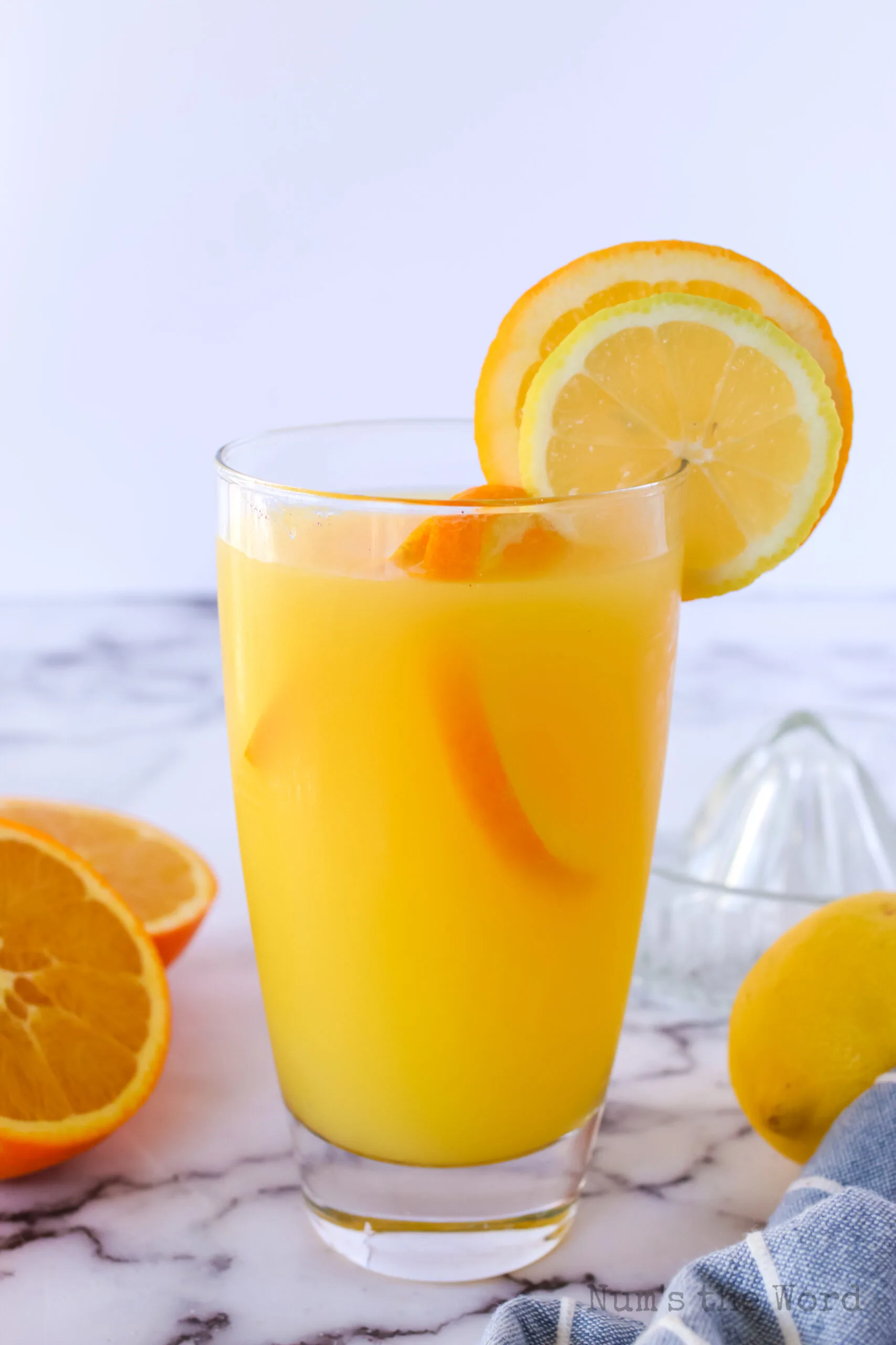 side view of orange lemonade in a glass