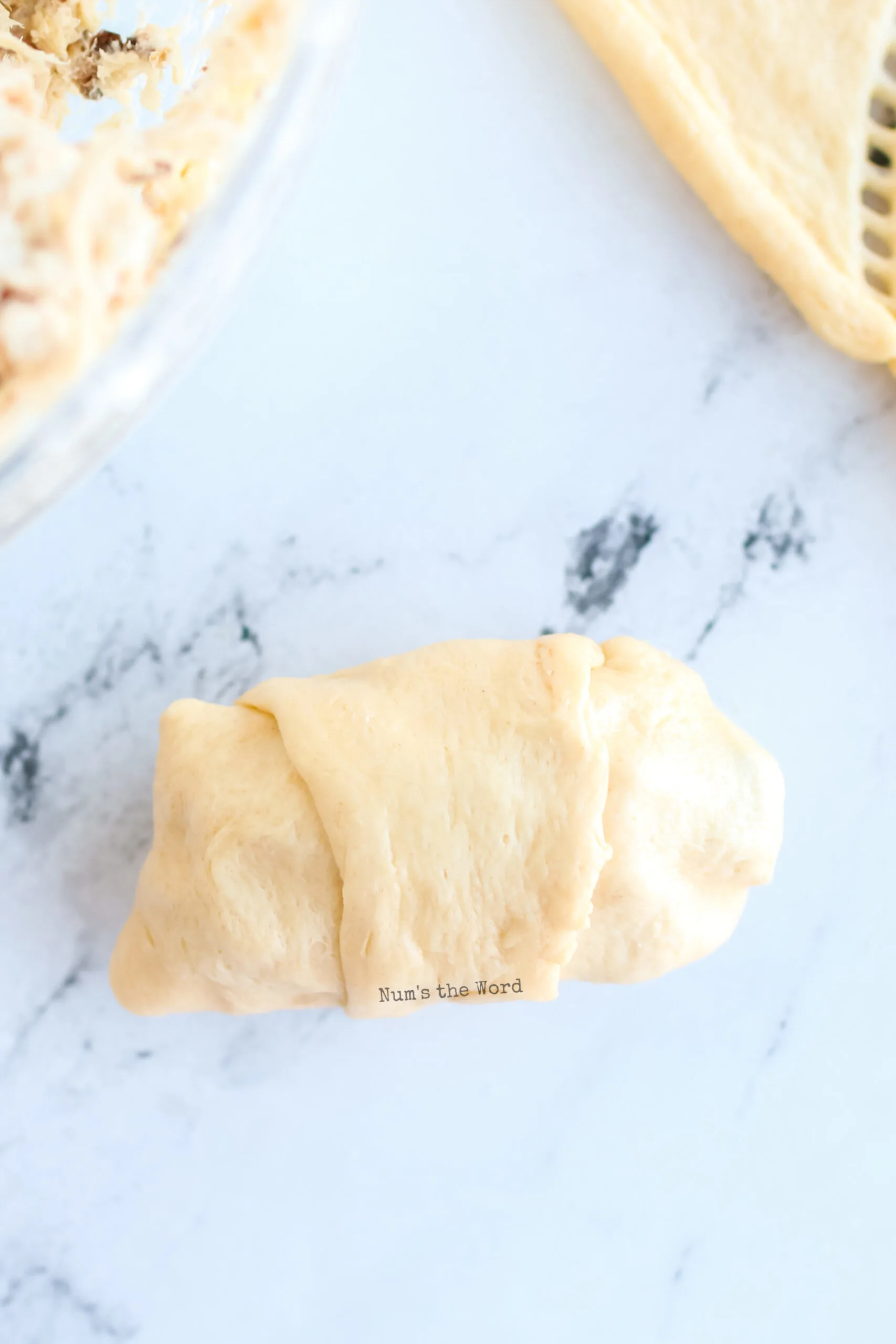 crescent roll wrapped around dollop of chicken to create a little pocket