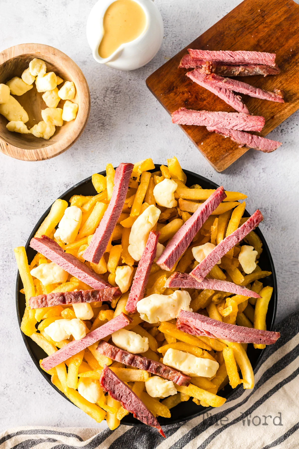 corned beef and cheese curds on top of french fries.