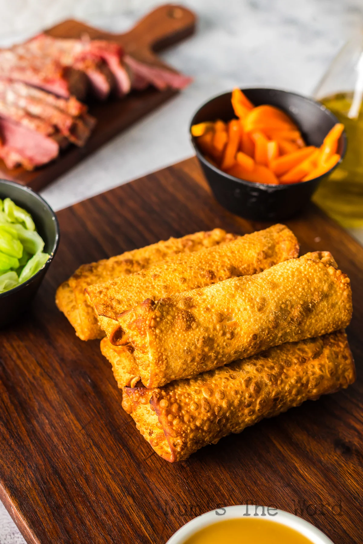 cooked egg rolls stacked up ready to serve.