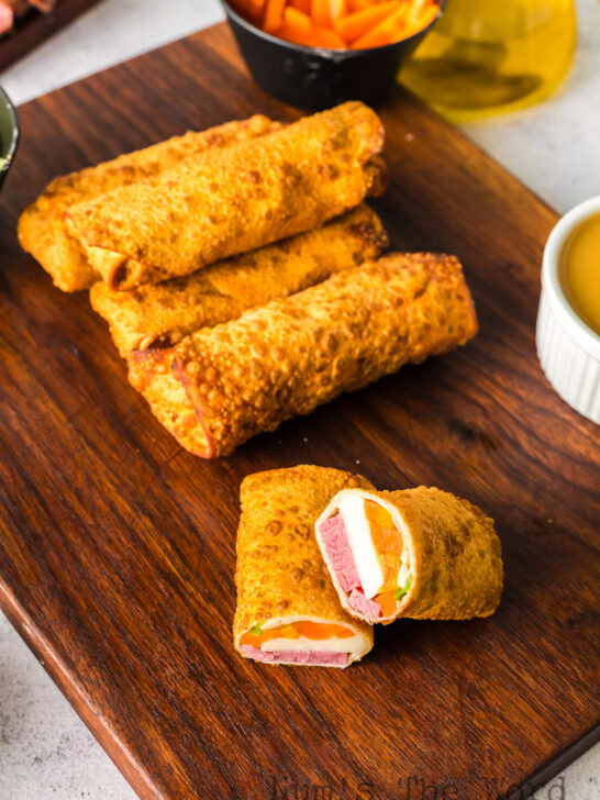 zoomed out image of cooked eggrolls with filling showing in one.