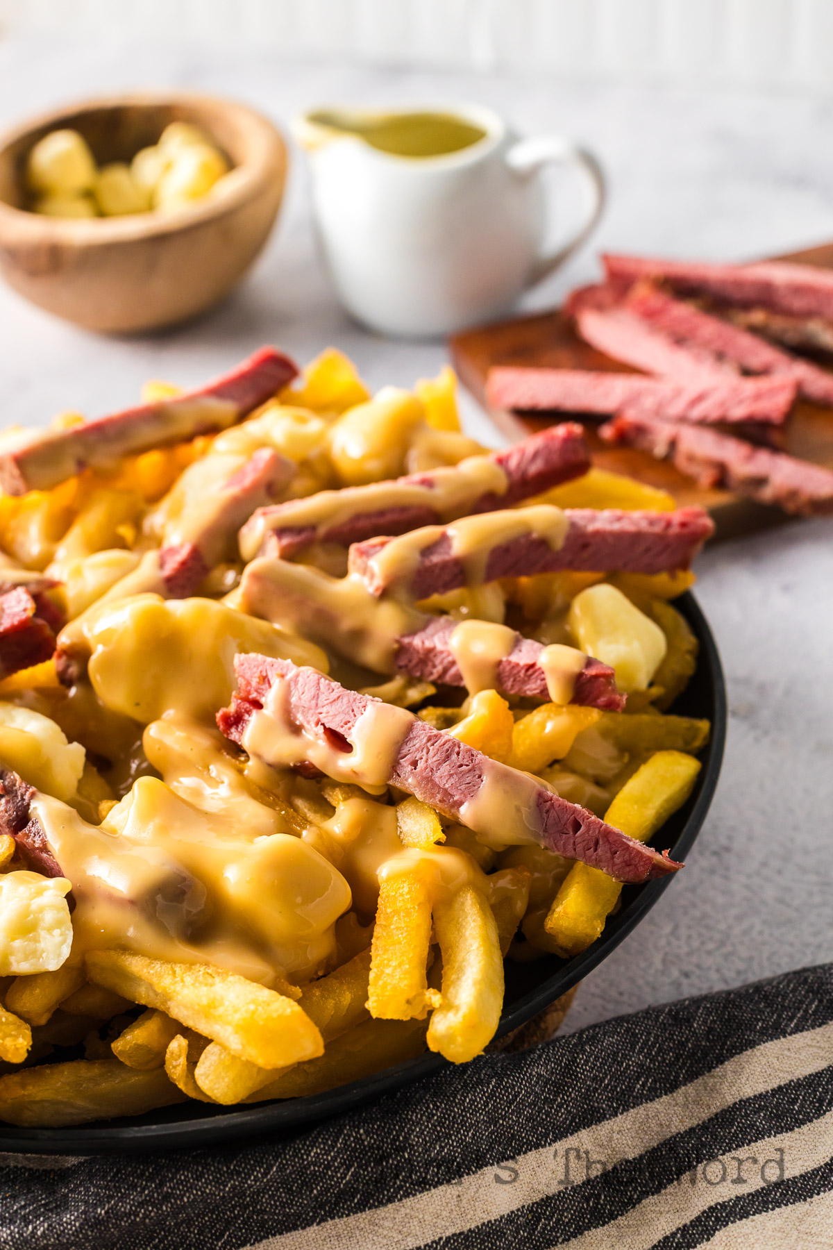 side view of poutine on a plate.