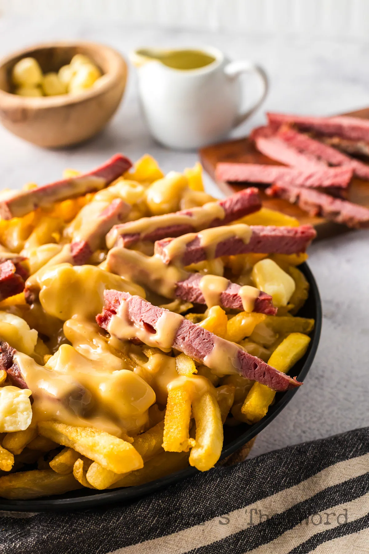 side view of poutine on a plate.