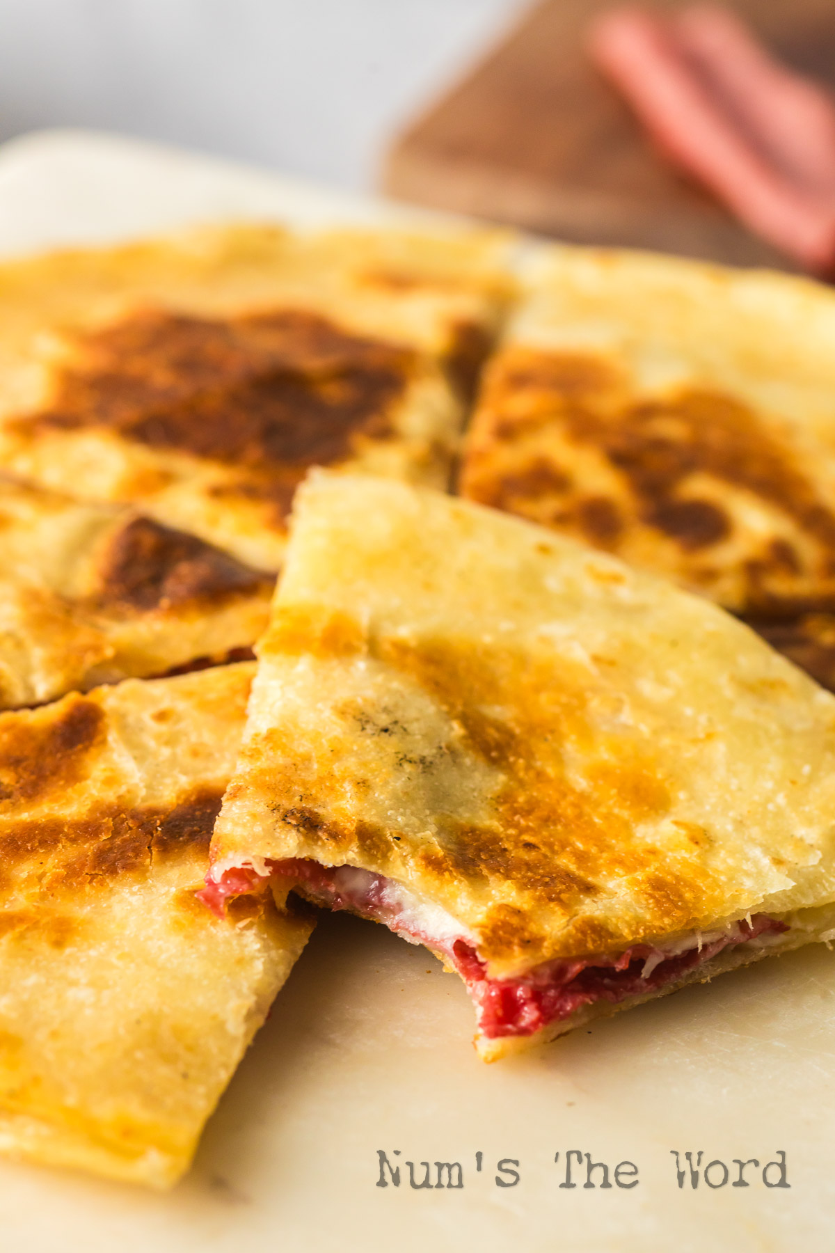 quesadilla on plate with a bite out of one slice.