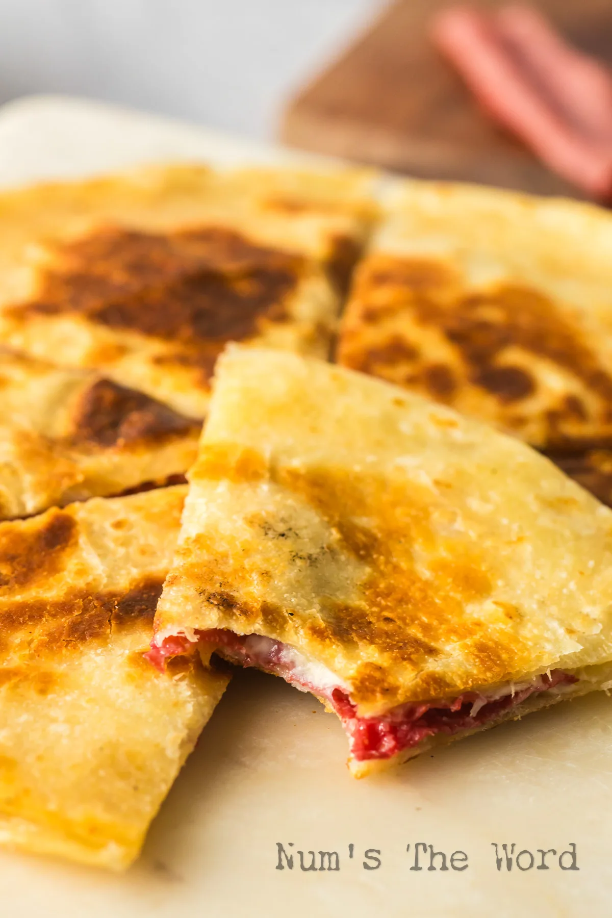 quesadilla on plate with a bite out of one slice.