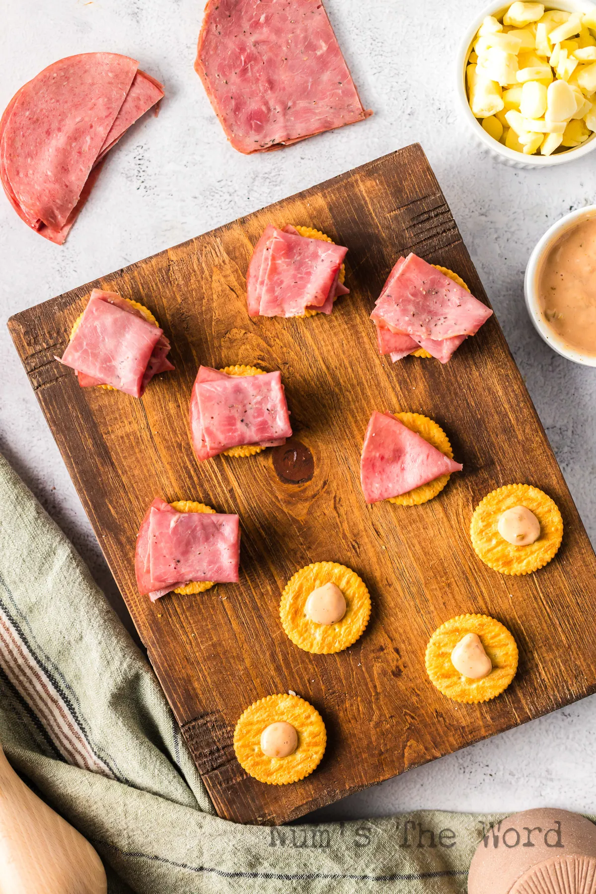 A slice of corned beef placed on top of dressing and cracker.