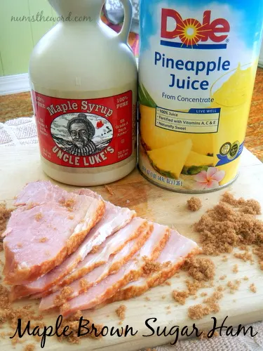 Maple Brown Sugar Ham - ham on a cutting board with brown sugar sprinkled on top! Main image for recipe!