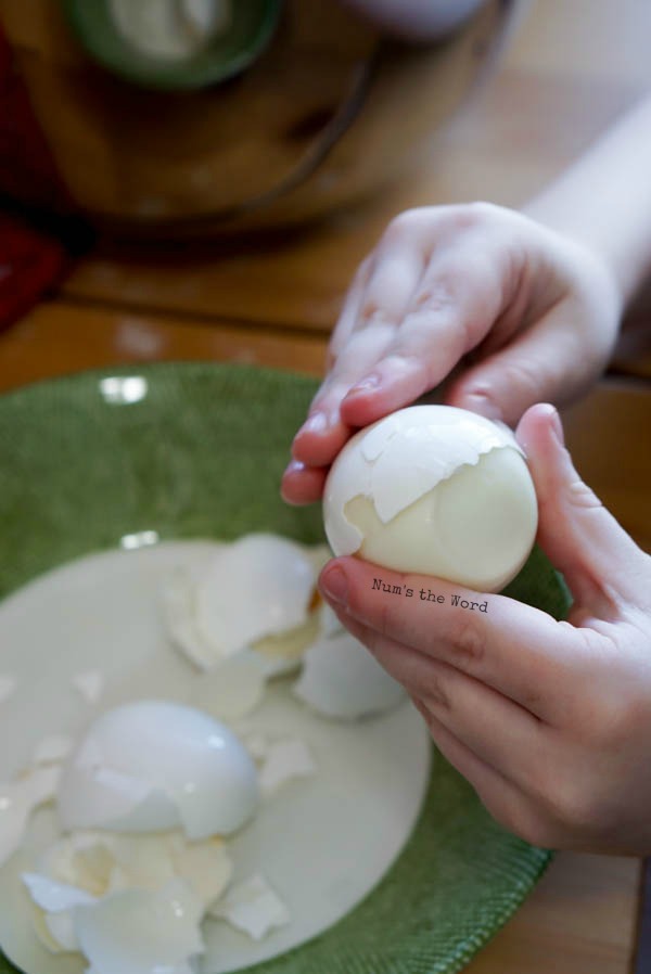 Childs hand peeling eggs. 