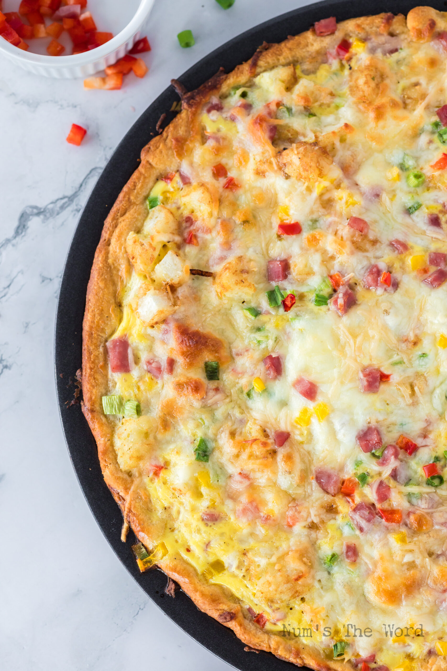 close up image of baked homemade breakfast pizza in pan
