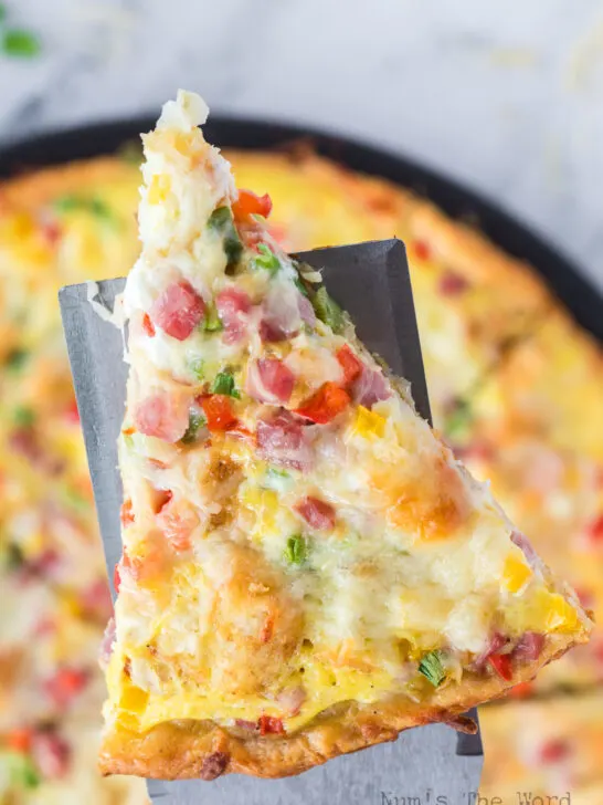 spatula lifting a pizza slice off pan.