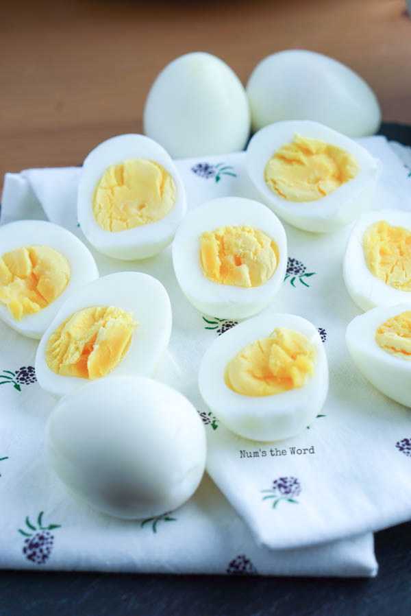 eggs cut in half on a dish cloth to show yummy cooked filling