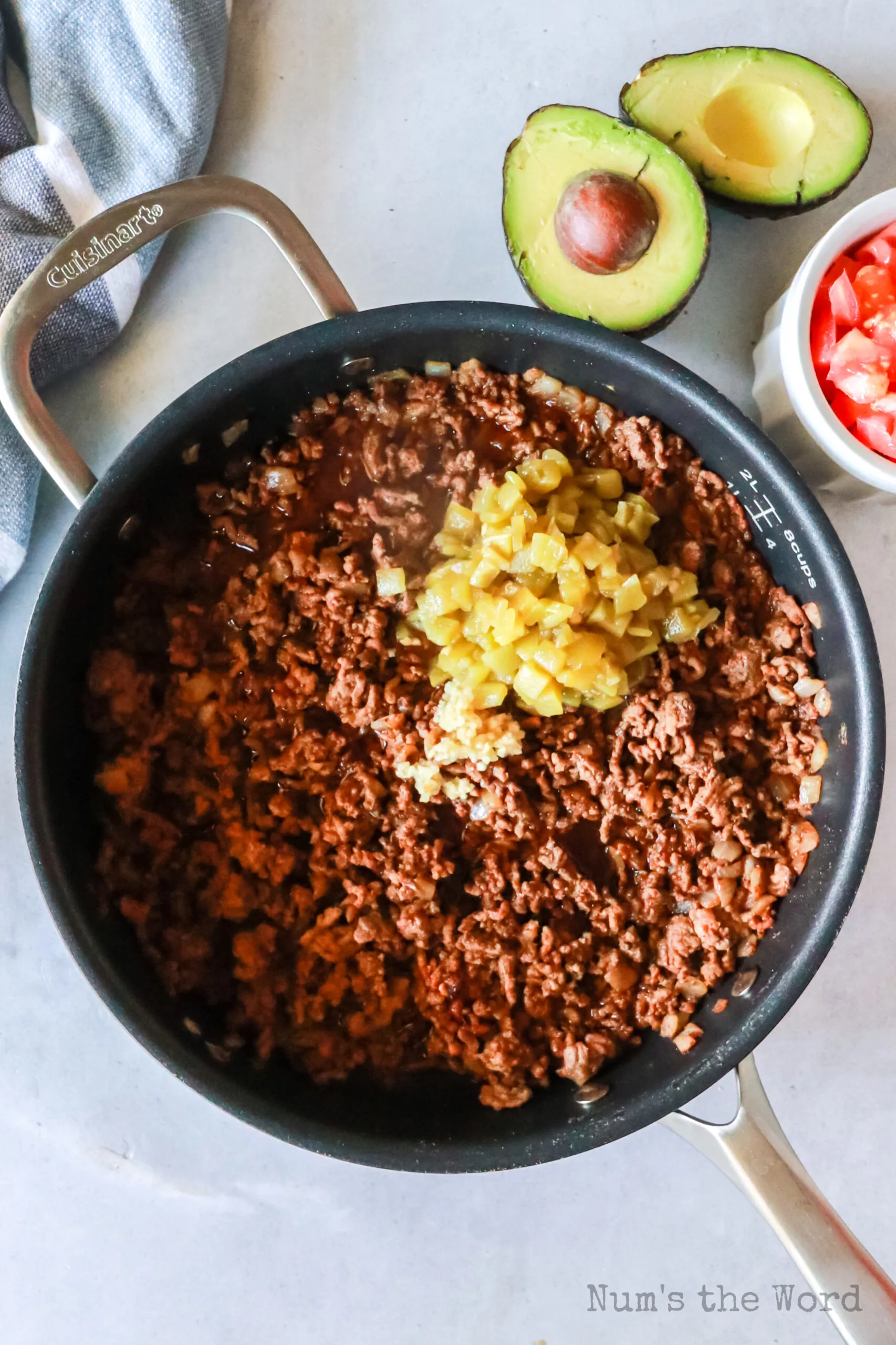 Garlic and green chilies added to cooked ground beef