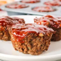 close up look of 3 mini meatloaf's on a plate.