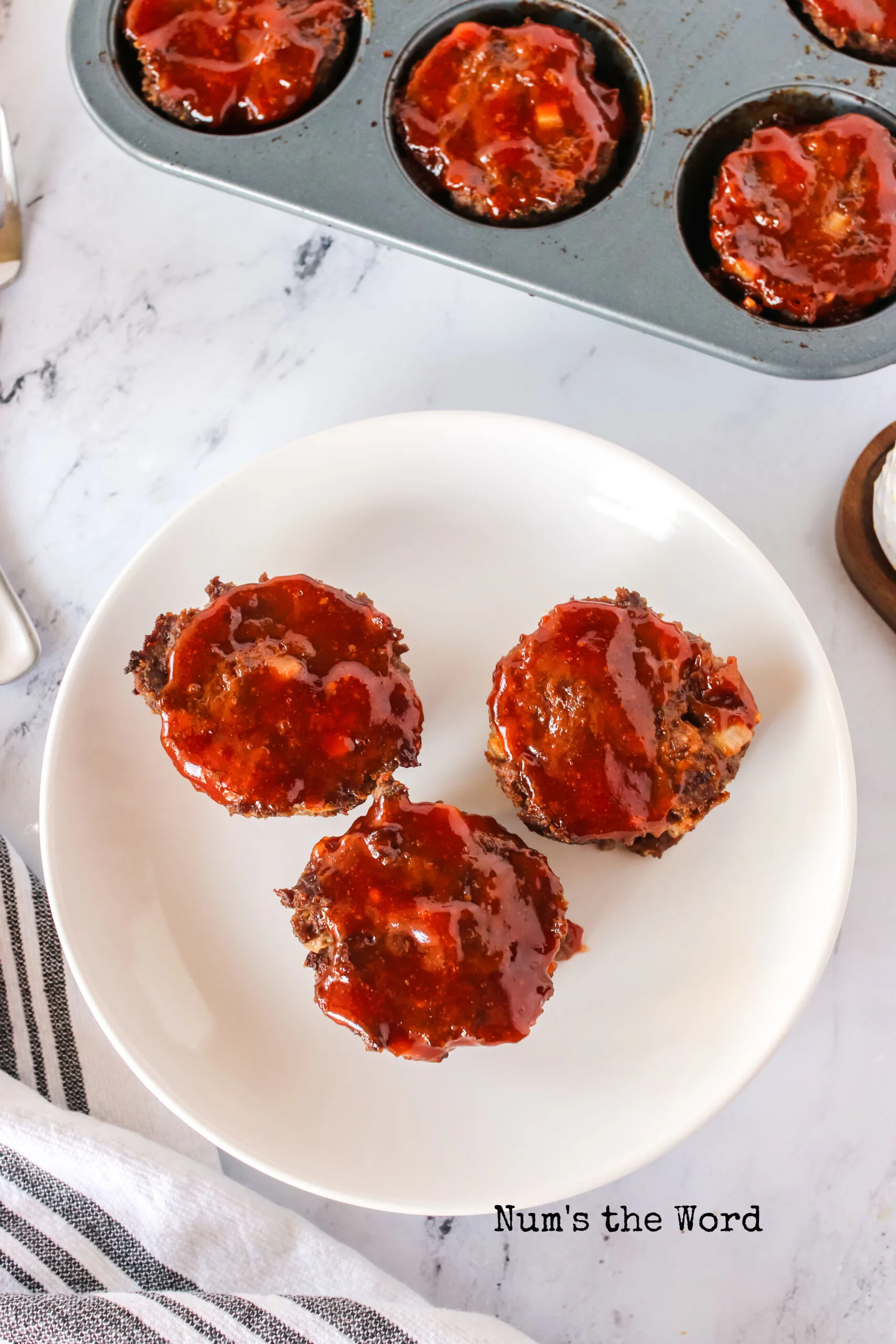 3 meatloaf muffins on a plate, top view