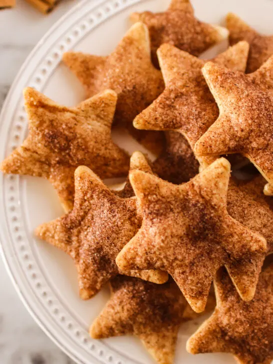 plate full of baked cinnamon sugar pie crust cookies