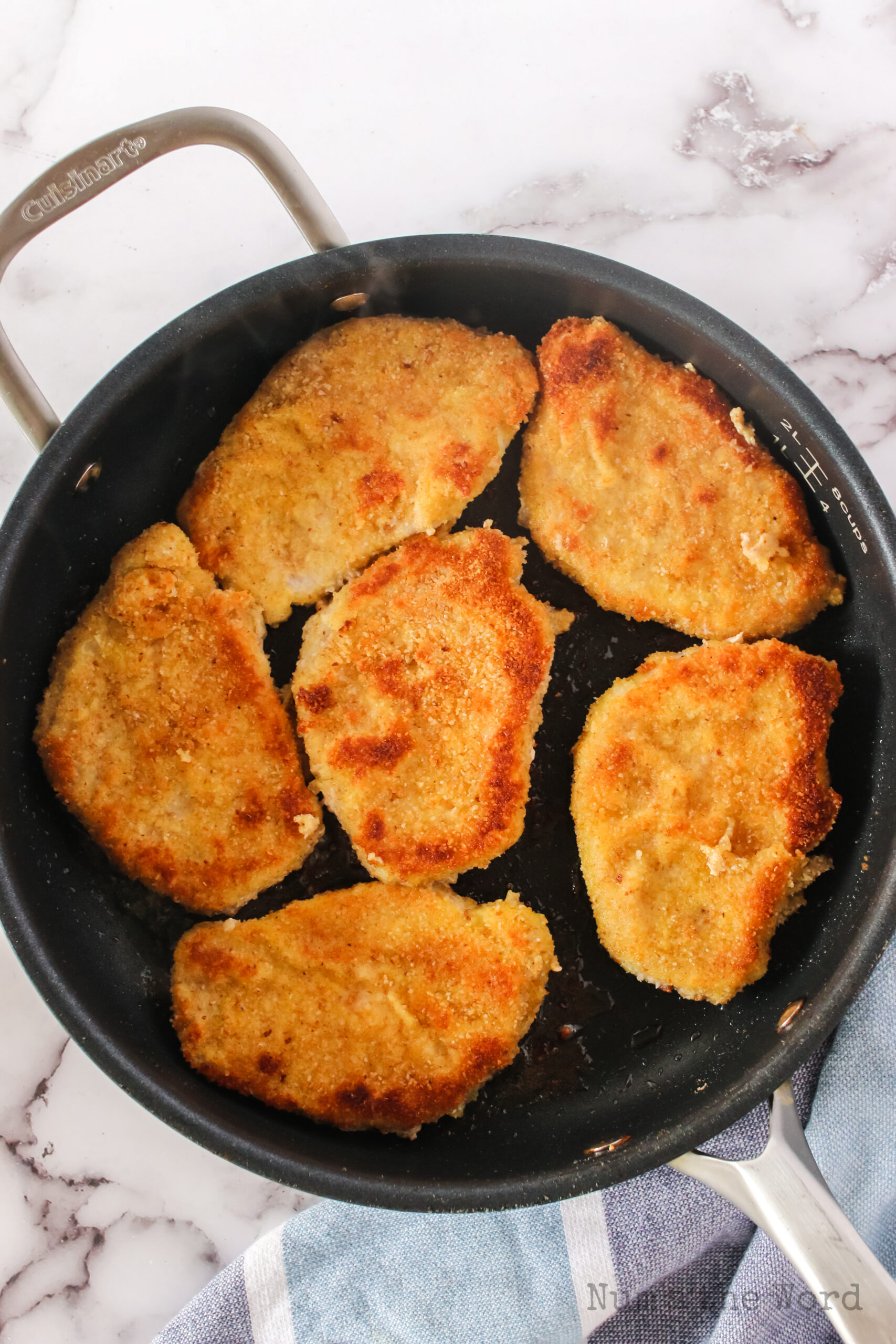 pork chops in skillet ready to fry