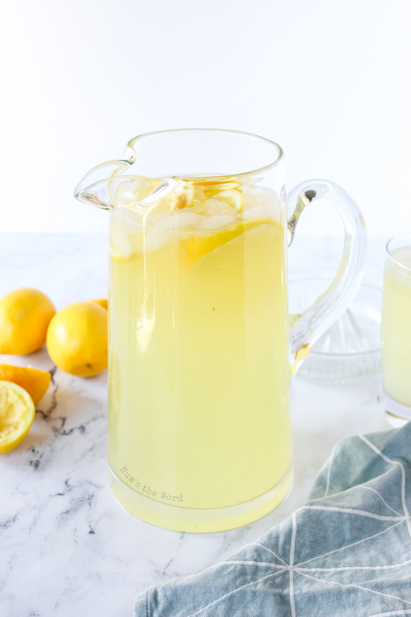 Zoomed out side view of lemonade in pitcher