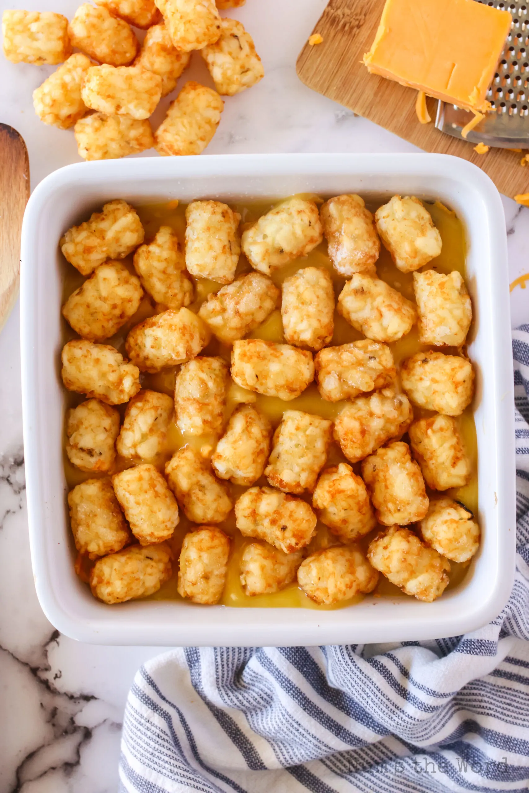 tater tots spread out on top of cream of chicken