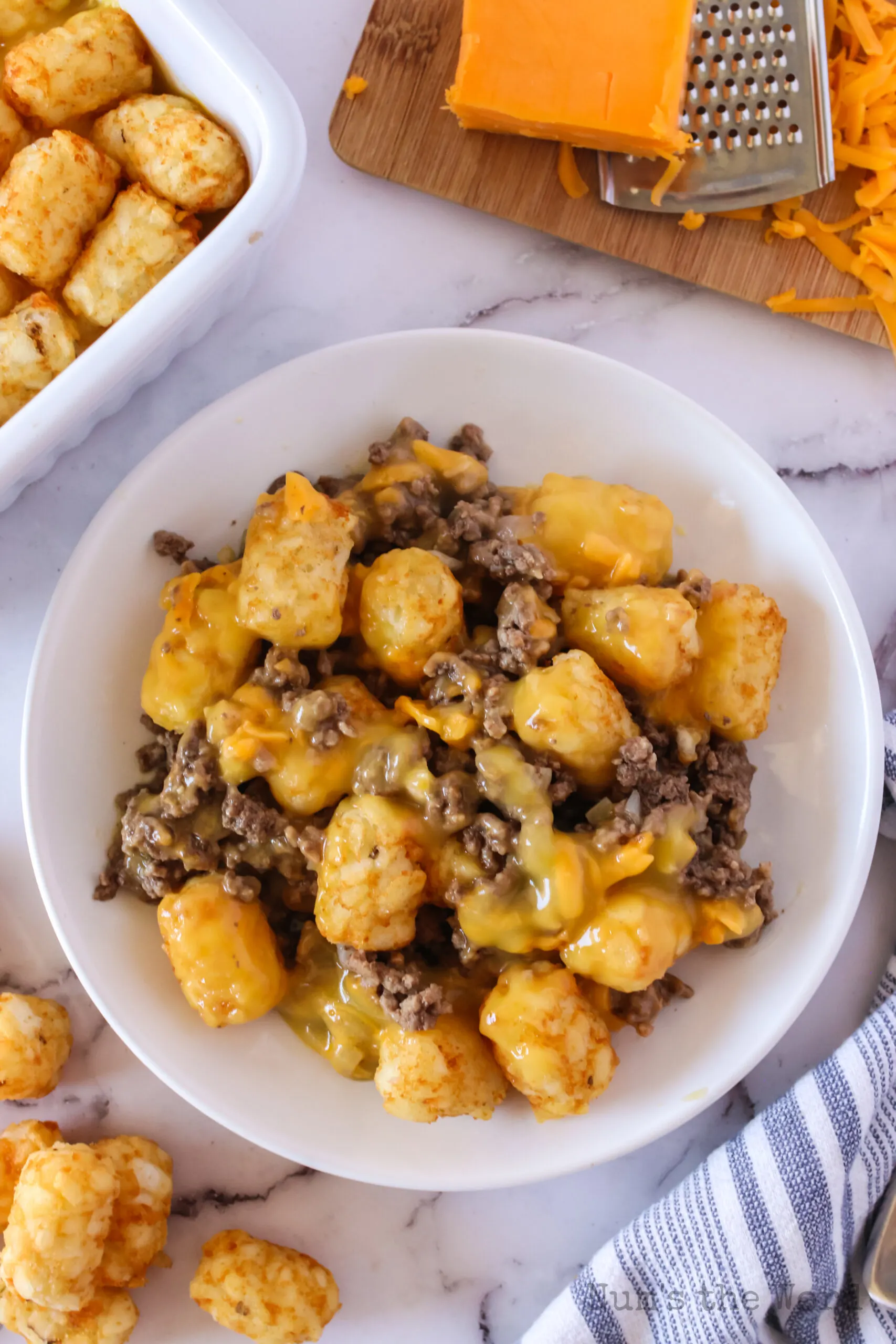 zoomed out plate full of cheesy tater tot casserole ready to serve