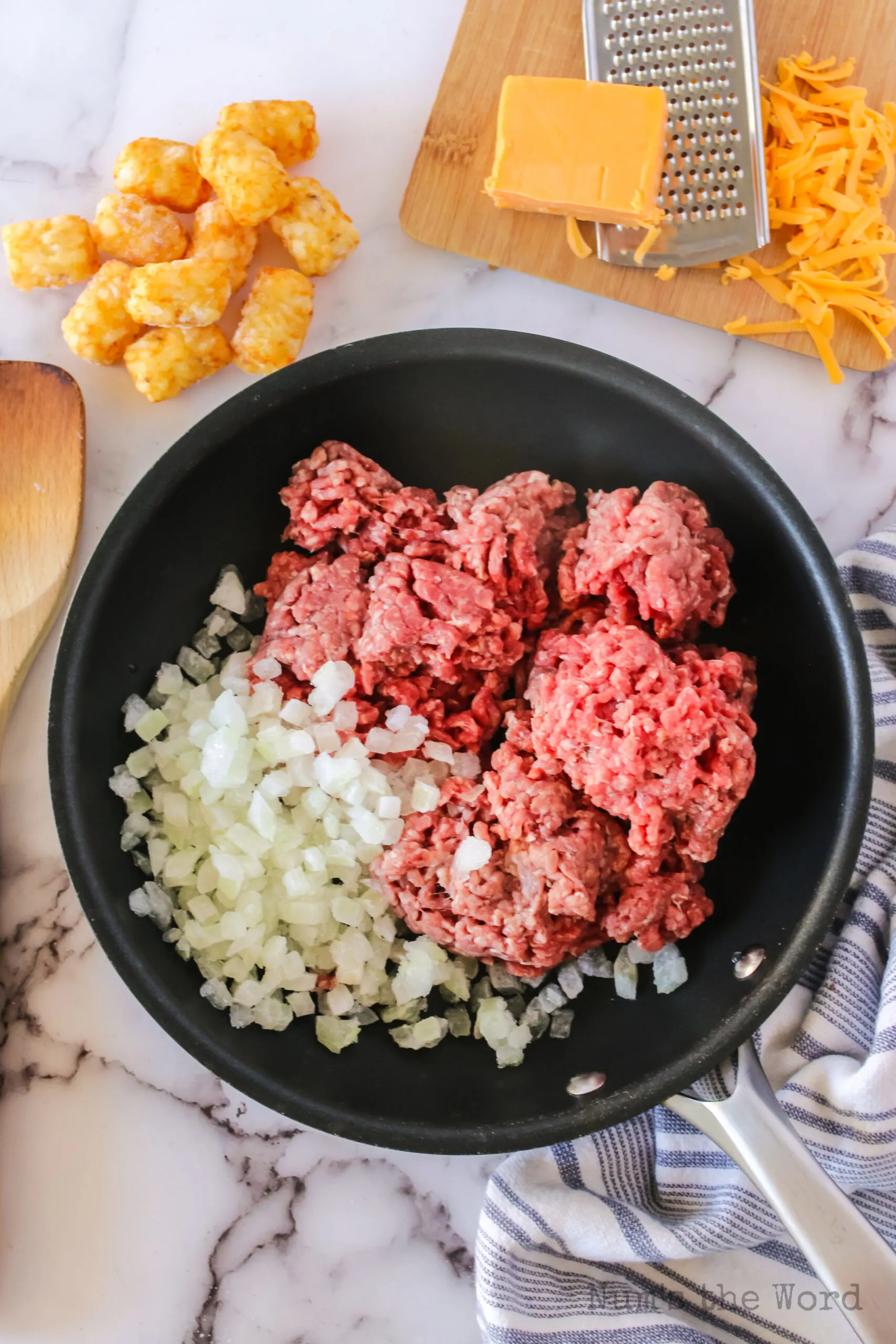 ground beef and onions in a skillet uncooked