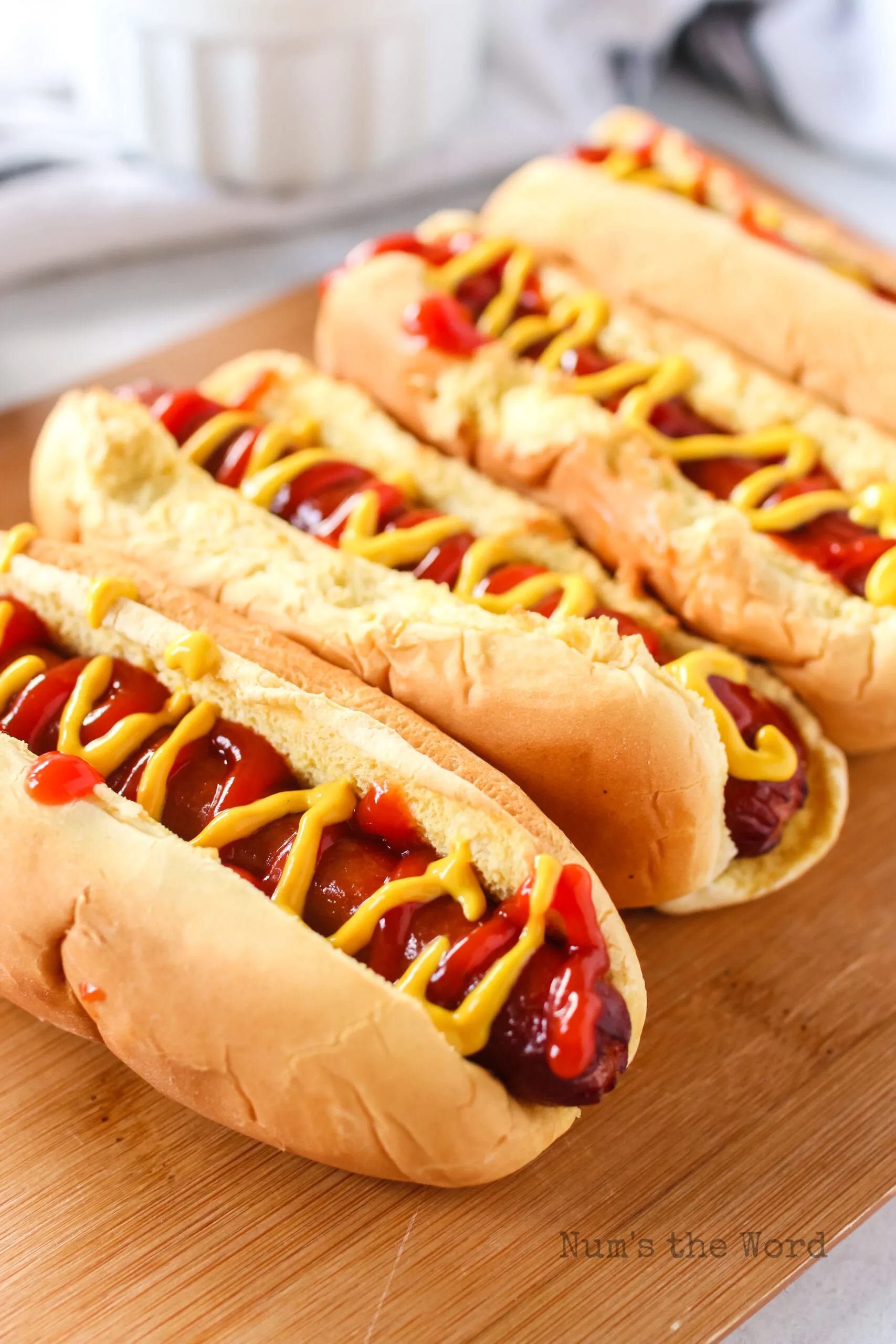 side angle view of hot dogs with ketchup and mustard.