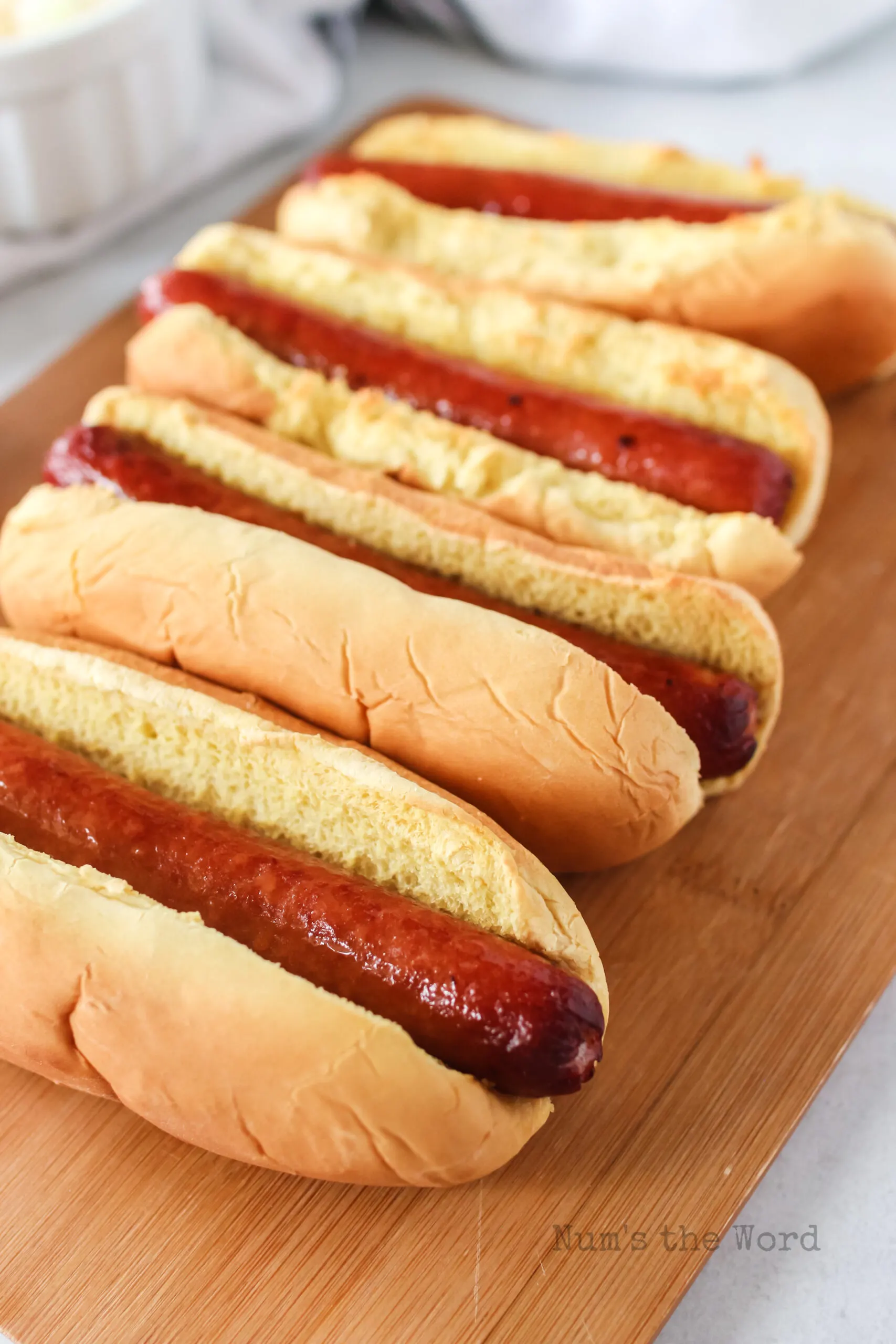 side angle of 4 hot dogs in buns out of air fryer.