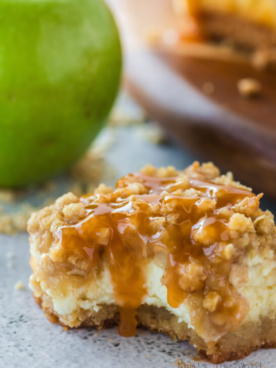 One caramel apple cheesecake bar on counter with a bite removed.