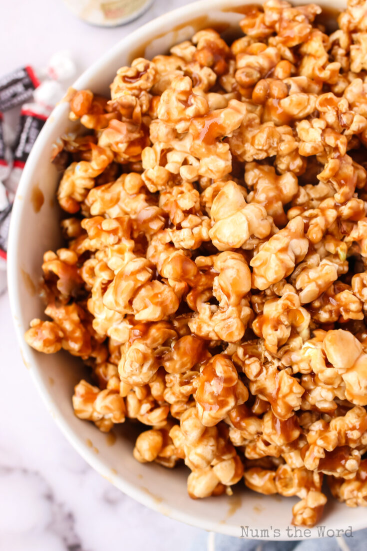 zoomed in image of caramel corn with tootsie rolls