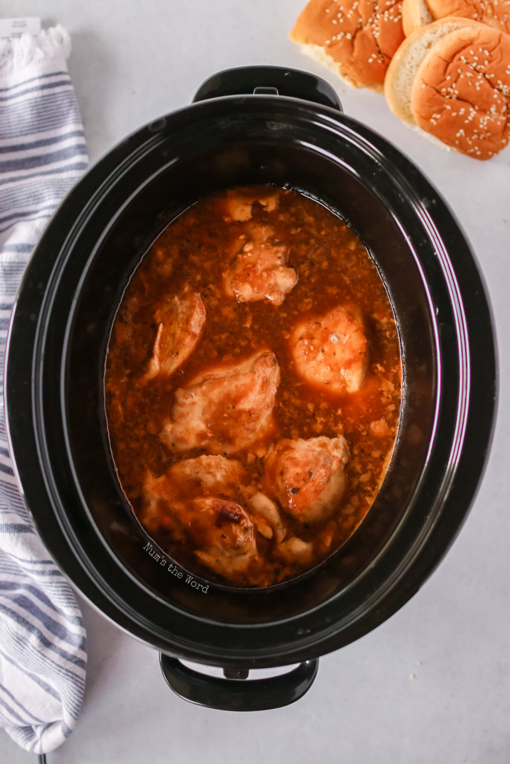 chicken cooked in sauce and ready to be pulled