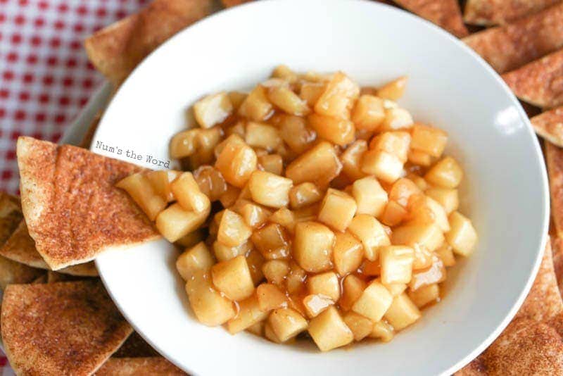 Apple Pie Dip - cinnamon sugar tortilla chip resting on bowl with apple pie dip