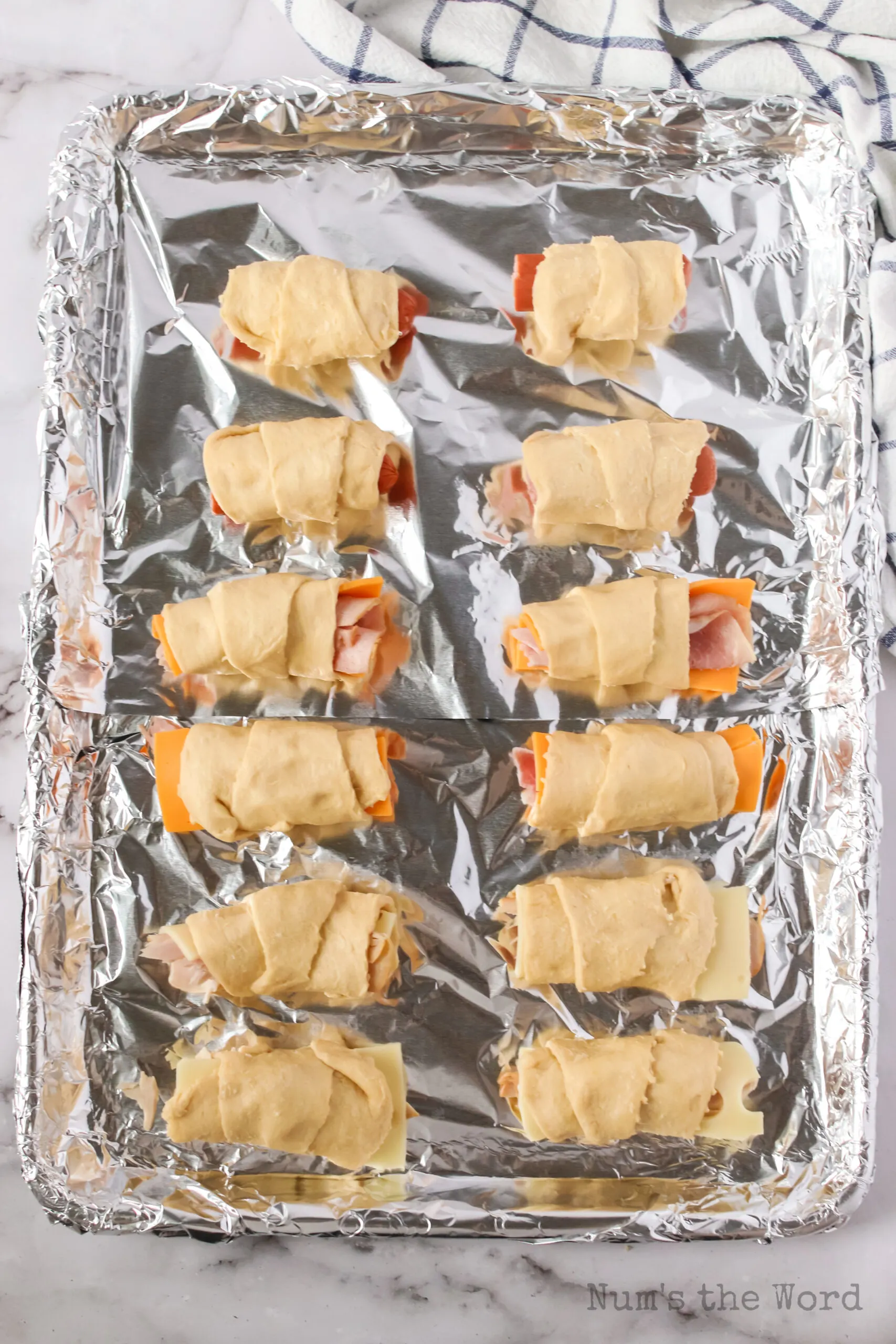 crescent roll ups on a baking tray, unbaked