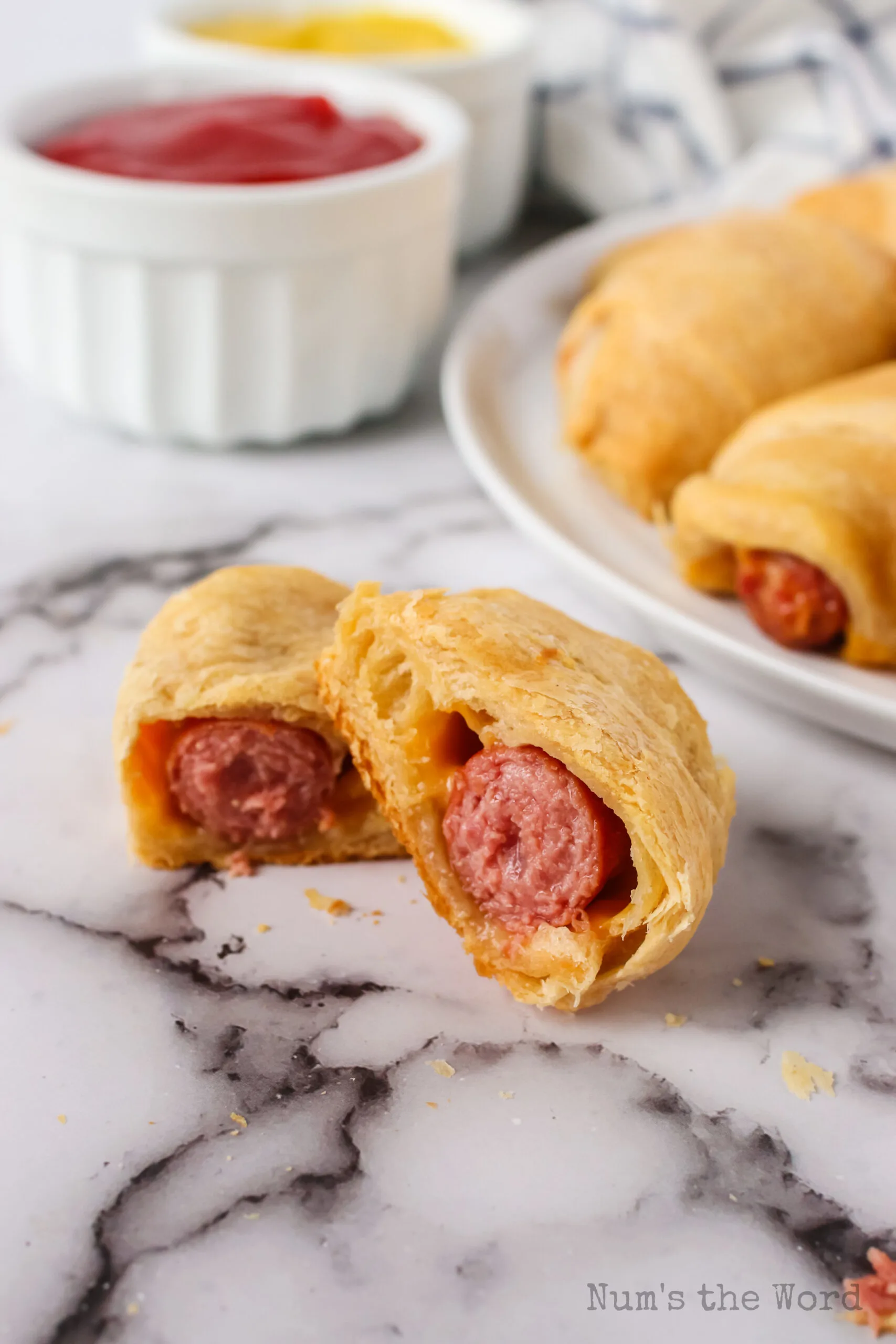 hot dog and cheese roll up cut in half to show filling