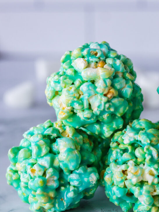 3 marshmallow popcorn balls stacked together to form a triangle