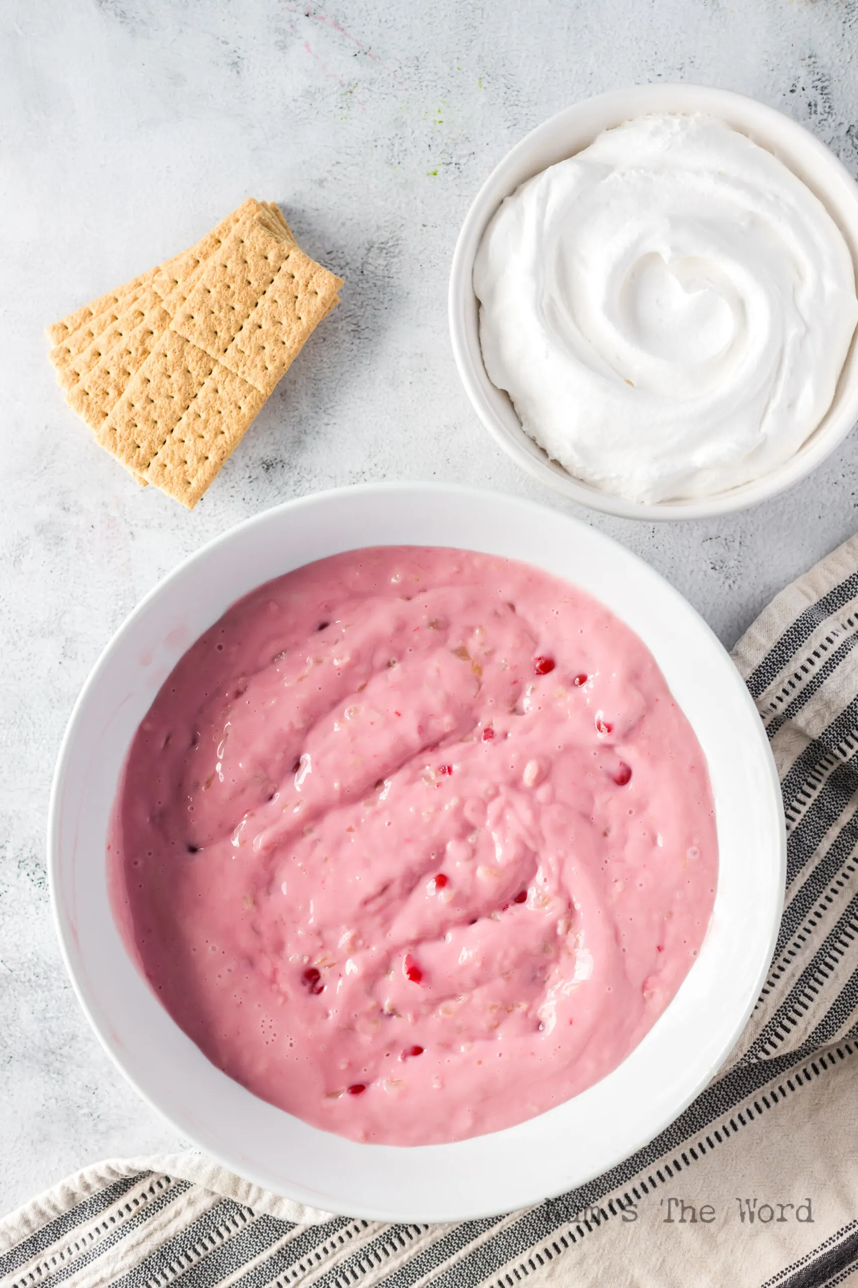 Cherry, pineapple and condensed milk mixed in bowl