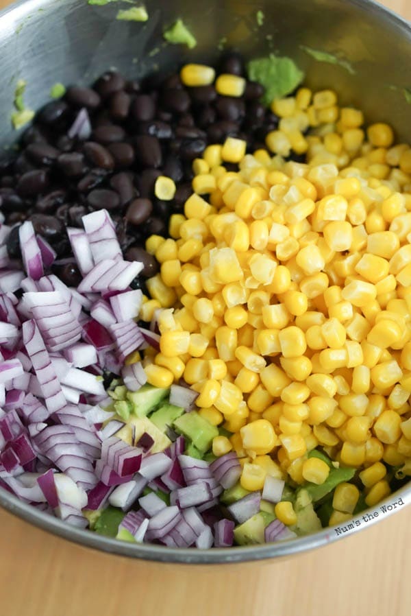 corn, black beans, onion, jalapeno, garlic and salt added to avocados