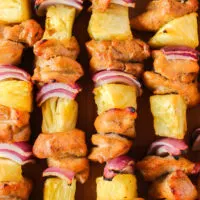 zoomed in image of kabobs on wooden platter