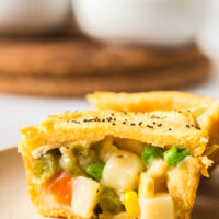Baked Chicken Pot Pie Stuffed Biscuit removed from muffin tin and cut in half to show creamy filling.