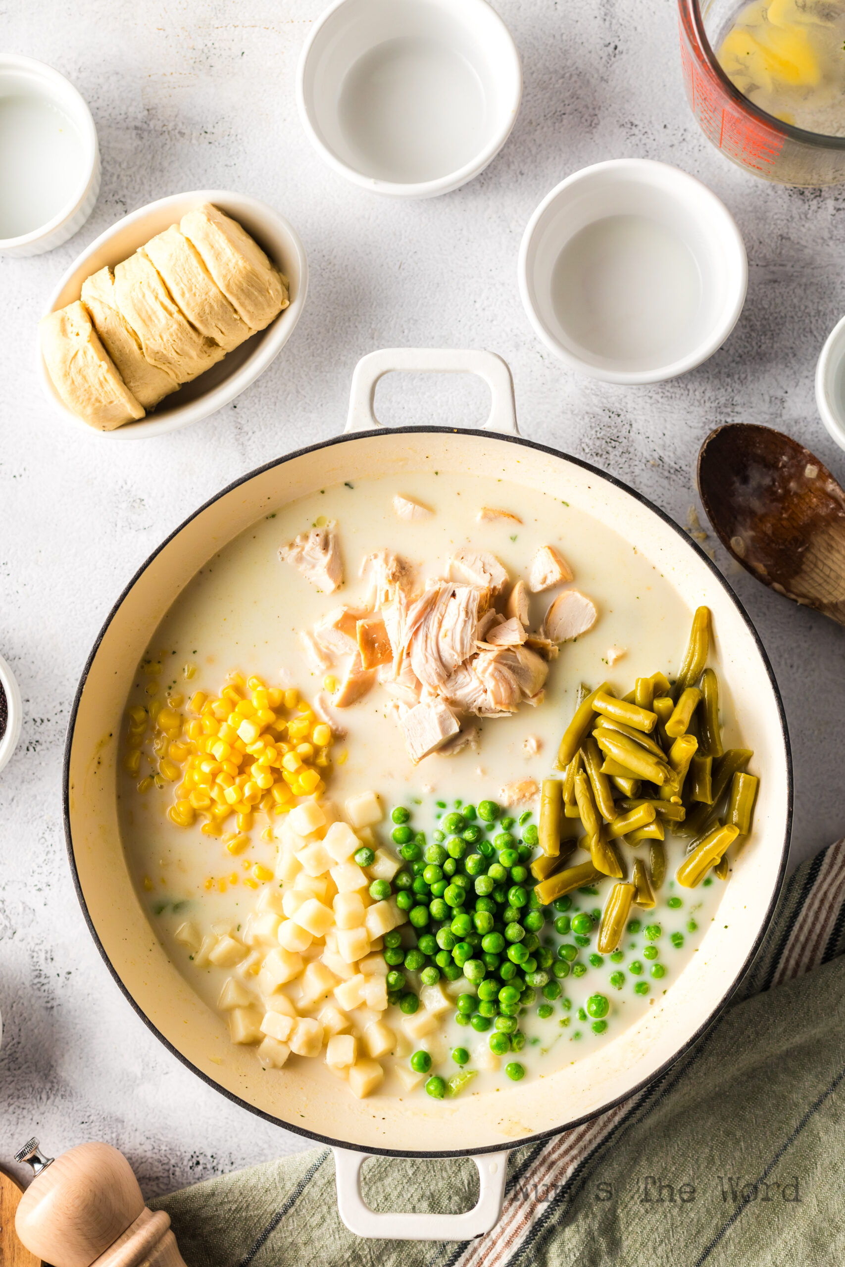 Chicken, Corn, potatoes, green beans and peas added to creamy mixture