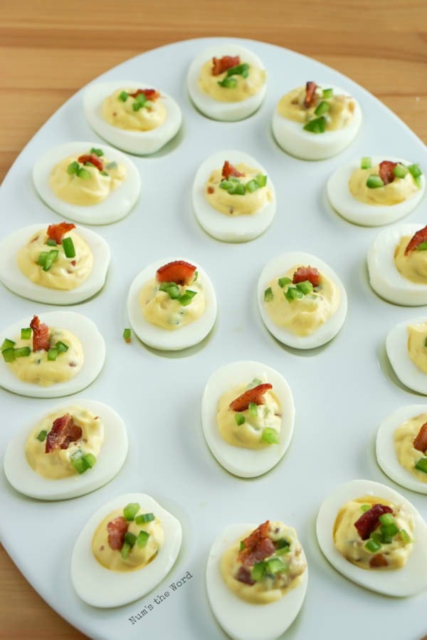 Bacon Jalapeno Deviled Eggs - eggs with filling and topped with tiny pieces of bacon and jalapenos