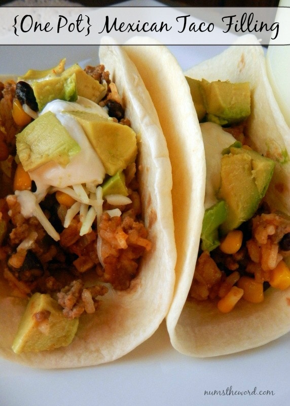 One Pot Mexican Taco Filling - Main image for Recipe of filling into a soft taco, topped with sour cream and fresh diced avocados