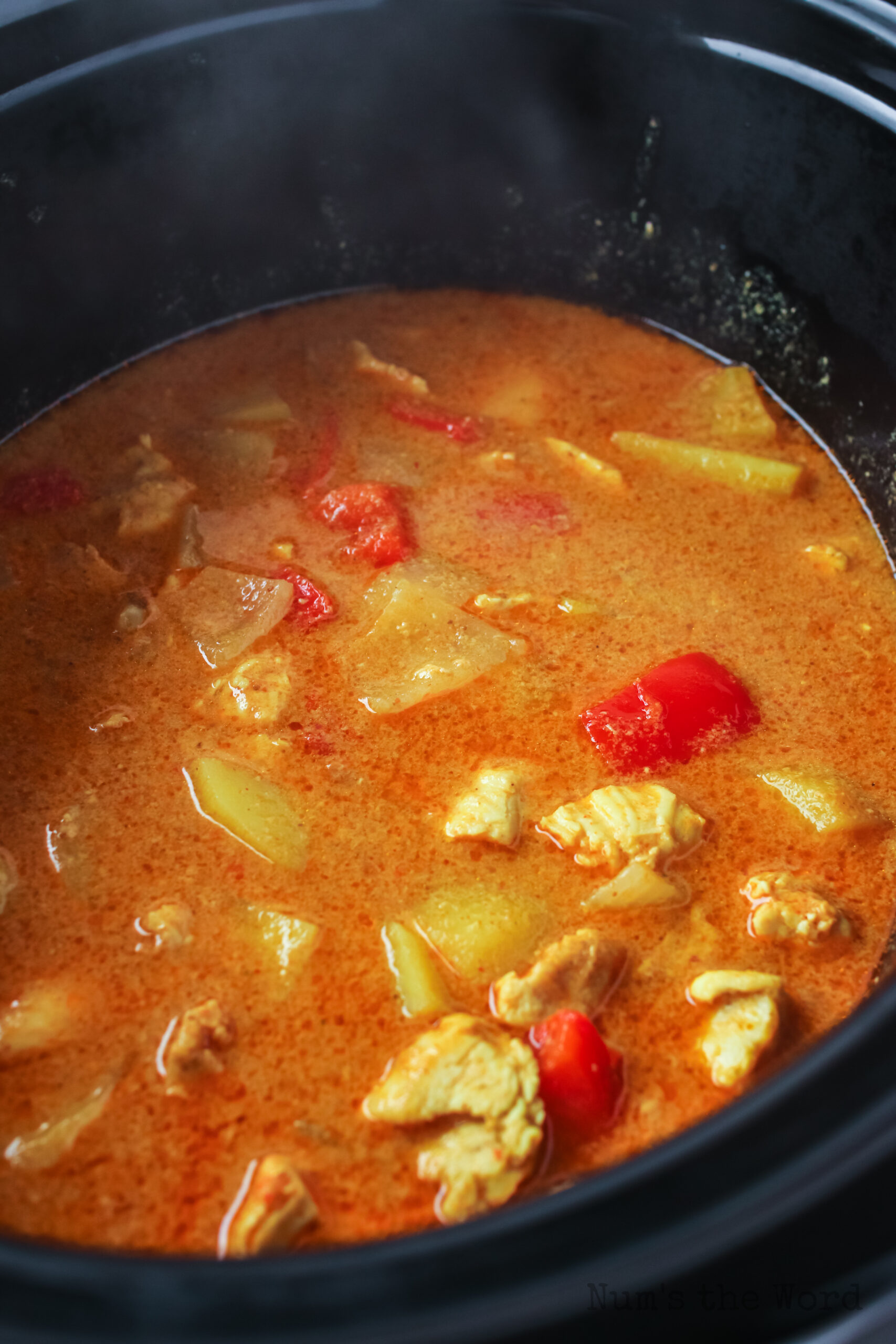 close up of yellow curry in slow cooker