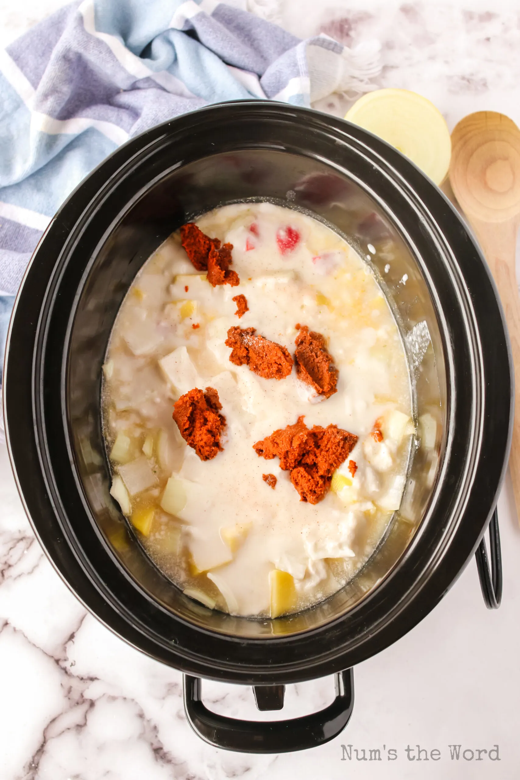 chicken broth, coconut milk and thai yellow curry paste added to vegetables in crock pot