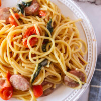 close up view of tomato basil sausage spaghetti on plate