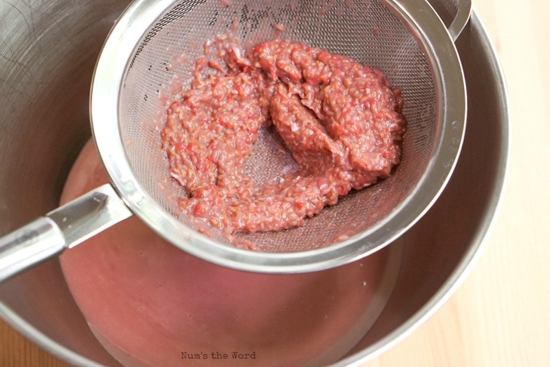 Homemade Raspberry Curd - seed mush in strainer leftover after straining