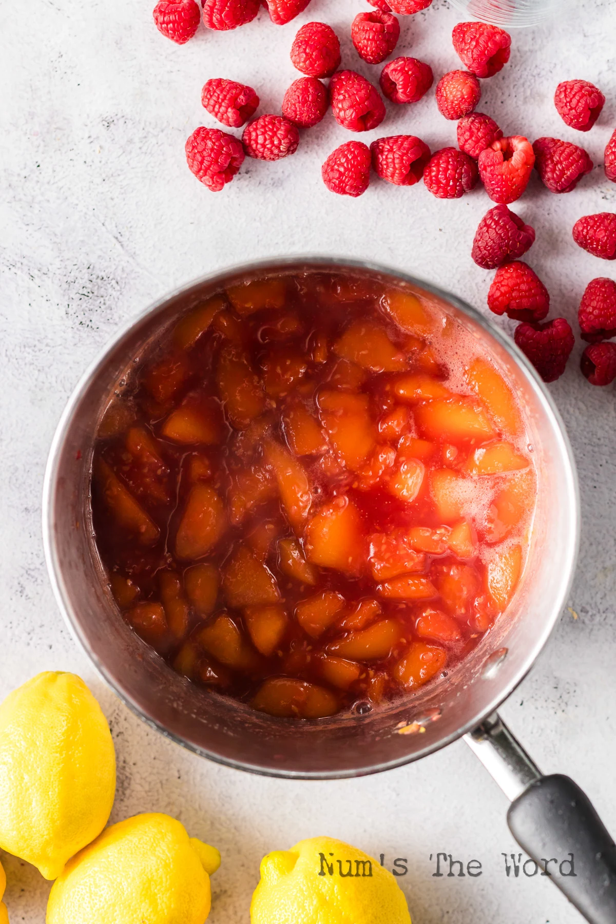 peach and raspberry mixture cooked down in pot.