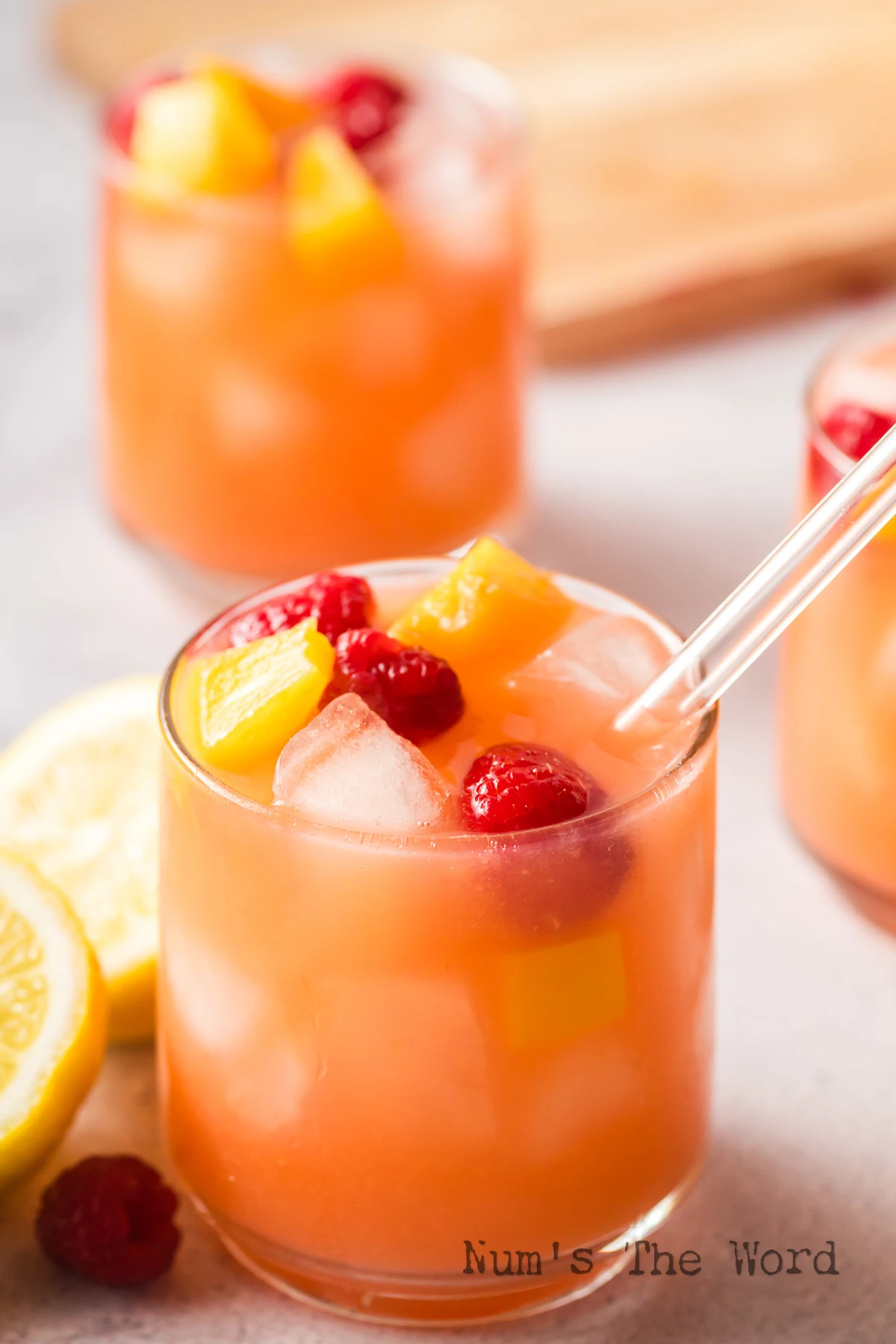 side view lemonade in a glass with a straw.