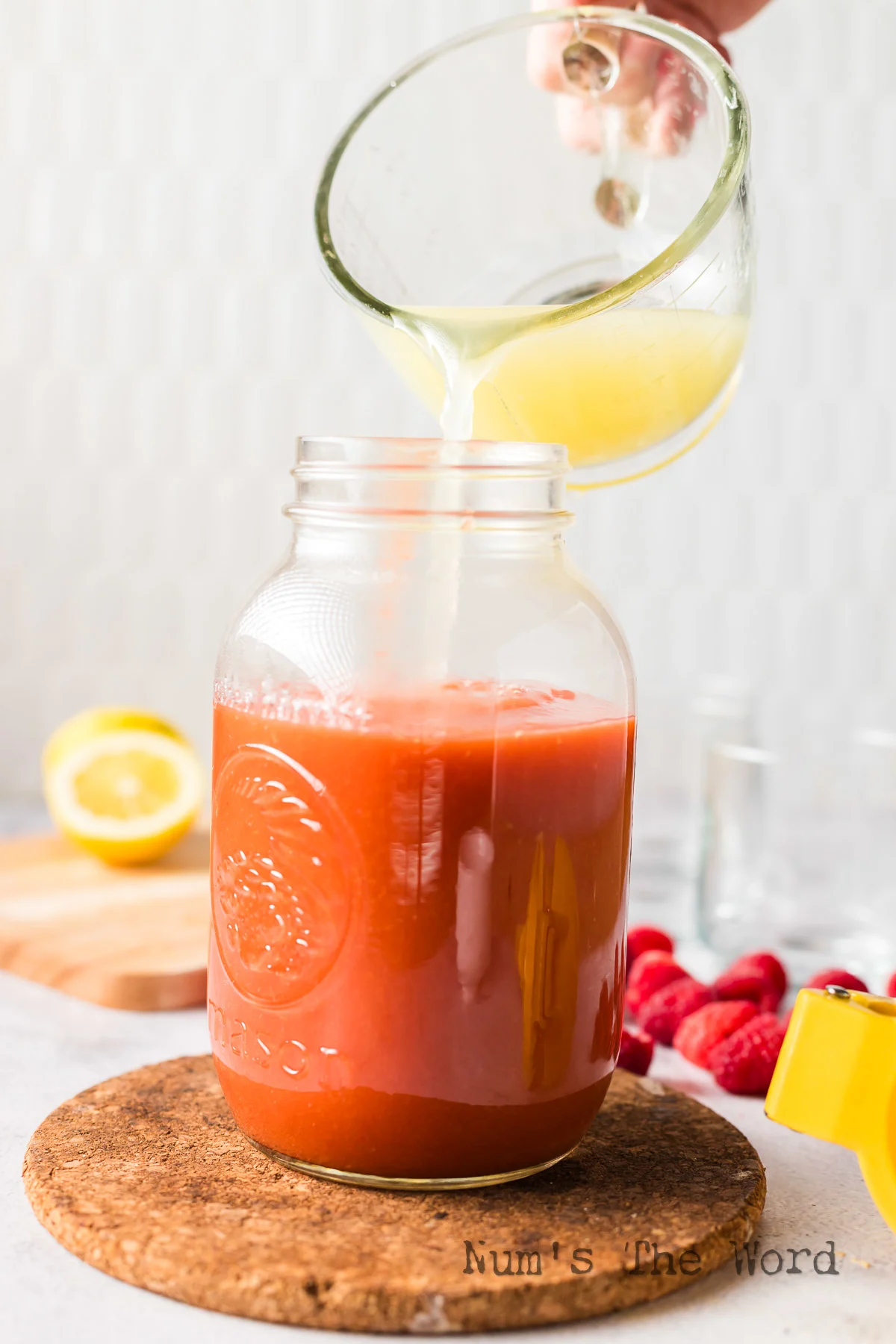 lemon juice being added to raspberry peach mixture.