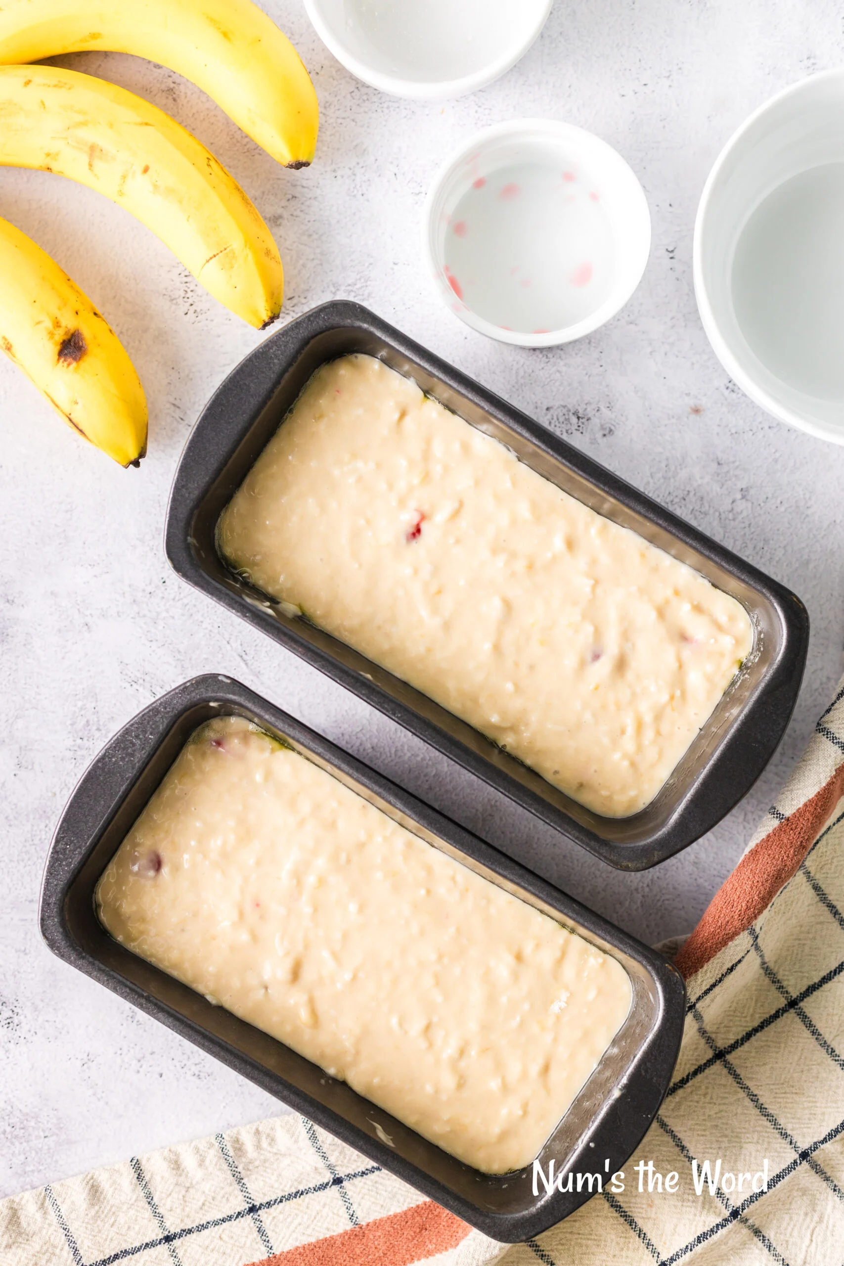 Bread batter added to bread pans, uncooked.