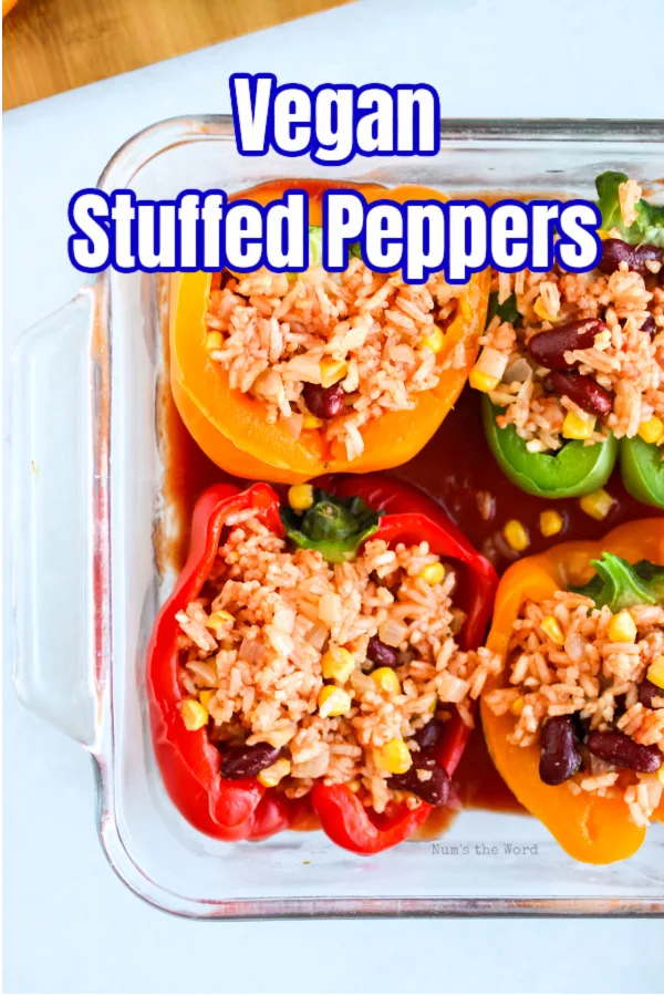 main image for recipe of vegan stuffed peppers in a casserole dish ready to be baked.