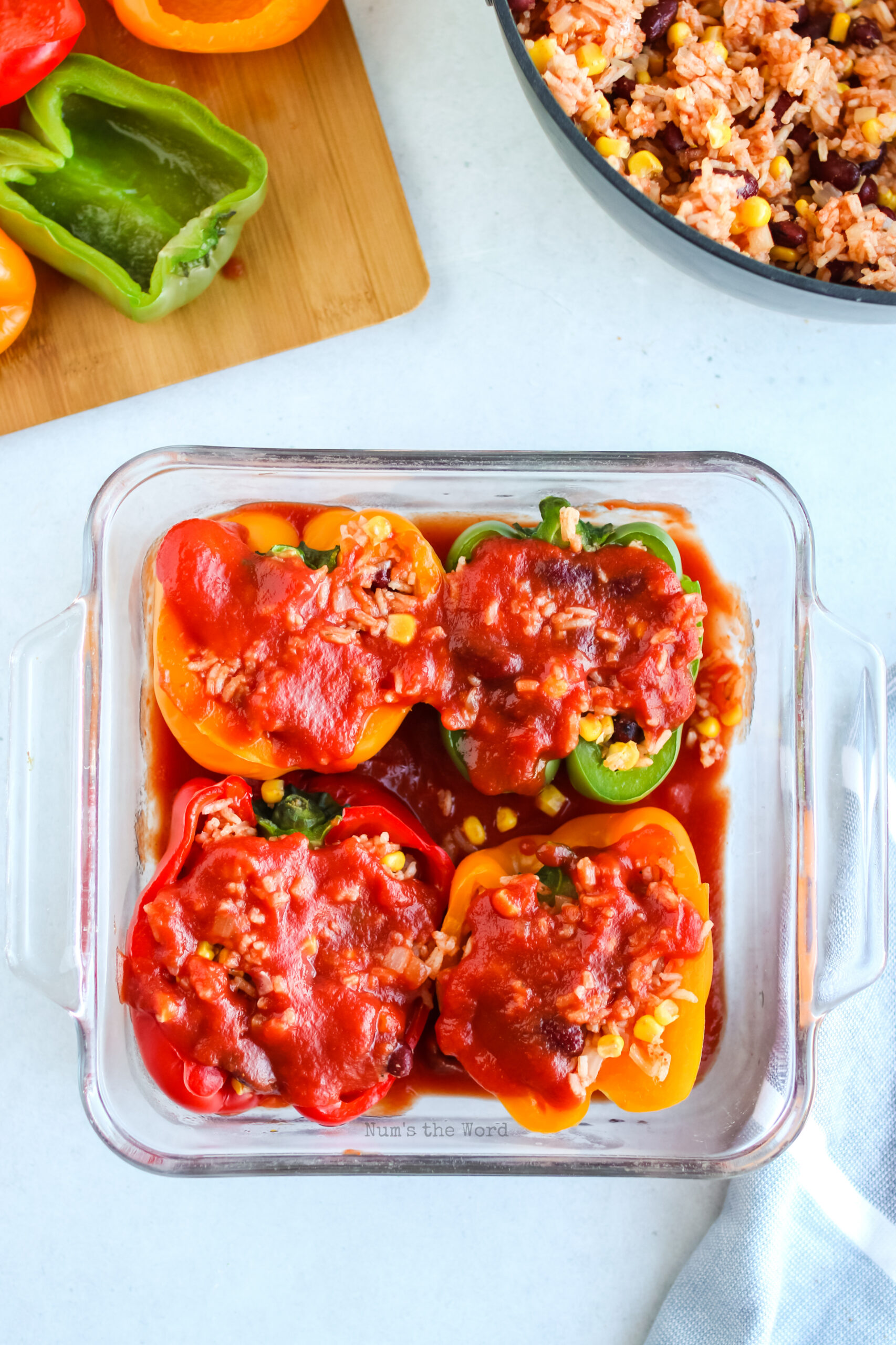 tomato sauce poured over filled peppers.